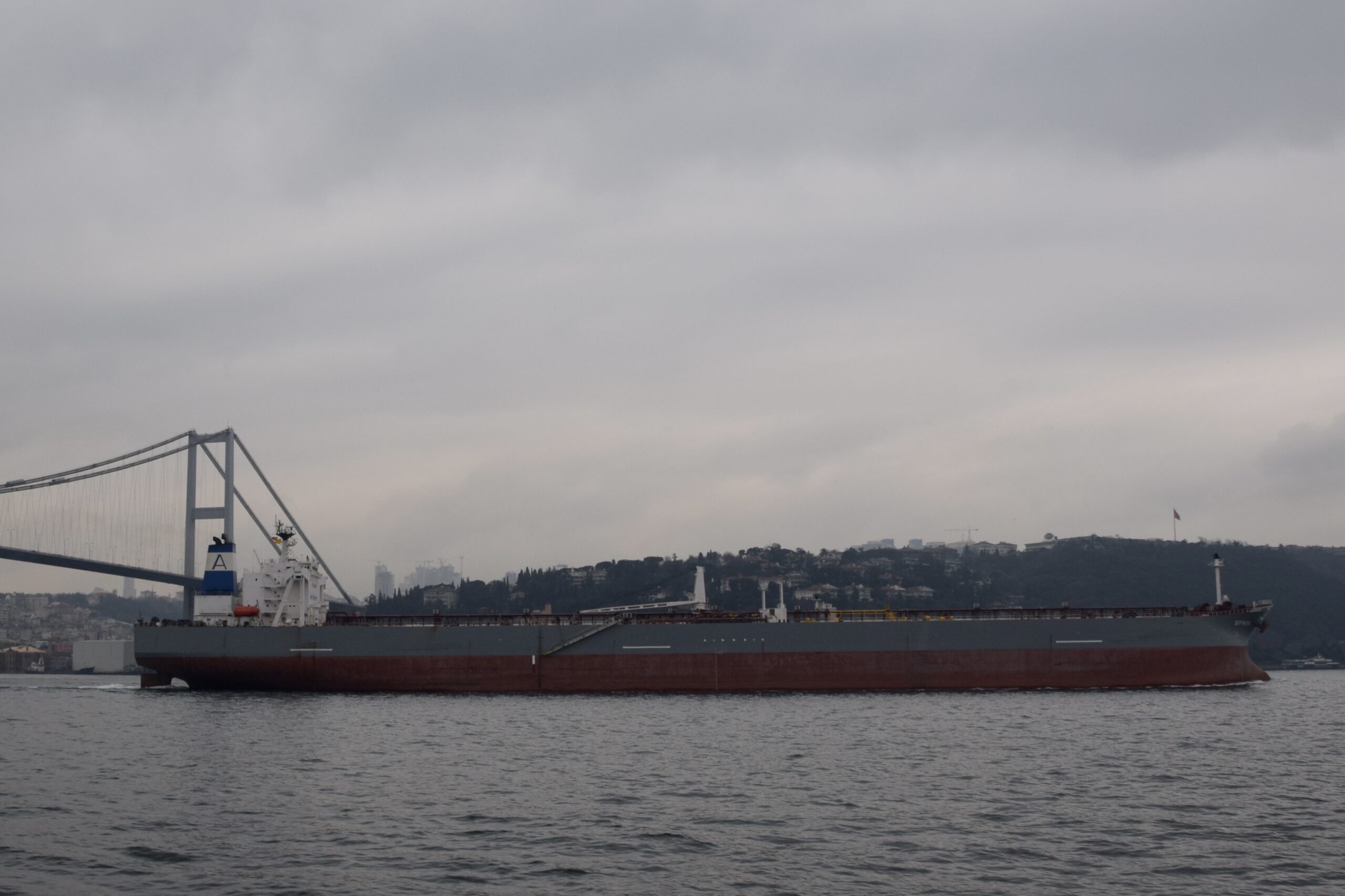 Crude oil tanker transiting the Strait of Hormuz between Iran and Oman