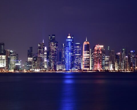 Doha West Bay skyline at night, Qatar — city towers reflected across the waterfront