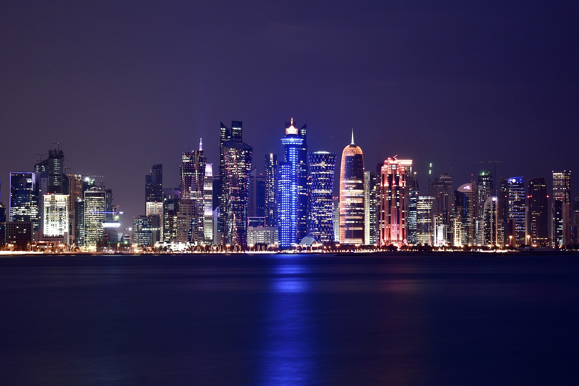 Doha West Bay skyline at night, Qatar — city towers reflected across the waterfront