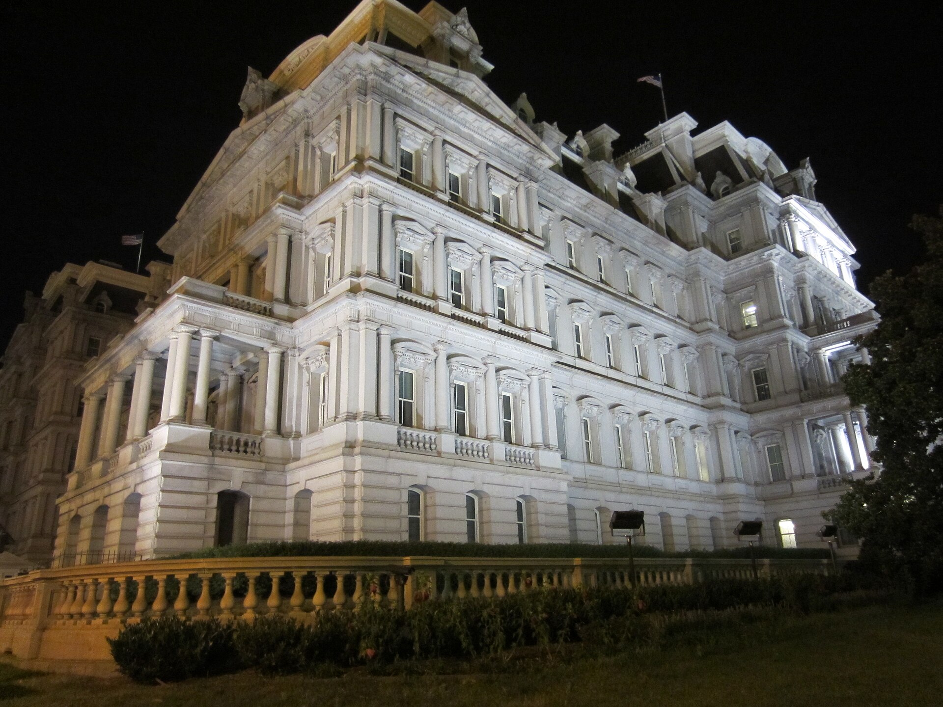 Eisenhower Executive Office Building illuminated at night, adjacent to the White House, where the National Security Council Situation Room is located