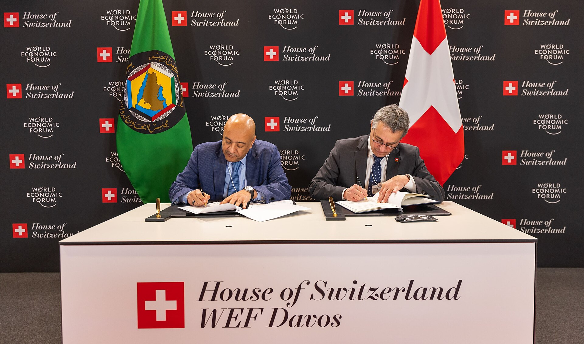 GCC Secretary-General Jasem Al-Budaiwi signs memorandum of understanding at World Economic Forum Davos 2026, with GCC flag visible
