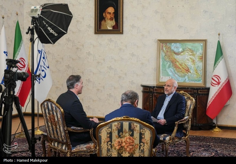 Iranian Parliament Speaker Mohammad Bagher Ghalibaf during CNN interview in Tehran, 2026, with an Iranian flag and map of Iran visible