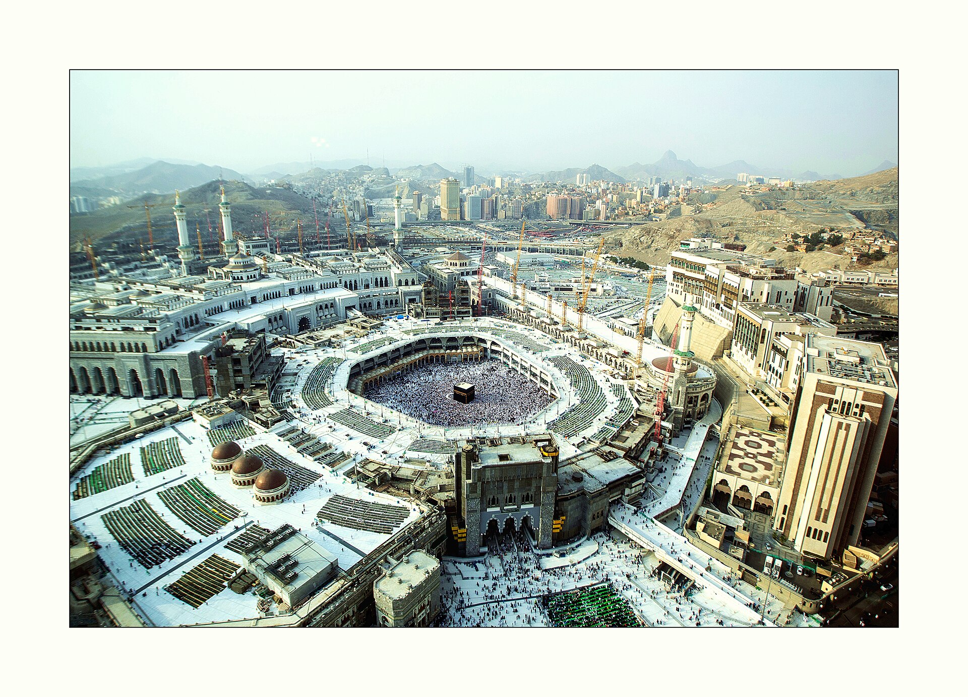 Aerial view of Masjid al-Haram in Mecca showing the Kaaba surrounded by thousands of pilgrims performing tawaf during Hajj season
