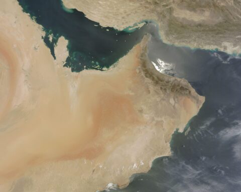 NASA MODIS satellite image showing the Gulf of Oman, Strait of Hormuz, and Persian Gulf — the full geographic extent of the IRGC 500-kilometer operational crescent from Jask to Siri Island