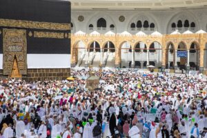 Thousands of white-clad pilgrims perform tawaf around the Kaaba at Masjid al-Haram, Mecca, during Hajj 2025 — the largest single gathering of Muslims on earth, now occurring while US B-2 bombers remain on alert and PAC-3 interceptors guard the same kingdom