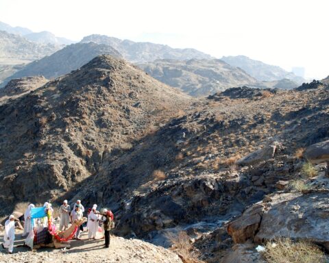Hajj pilgrims in white ihram garments approach the hills near Mecca during the annual pilgrimage, Saudi Arabia