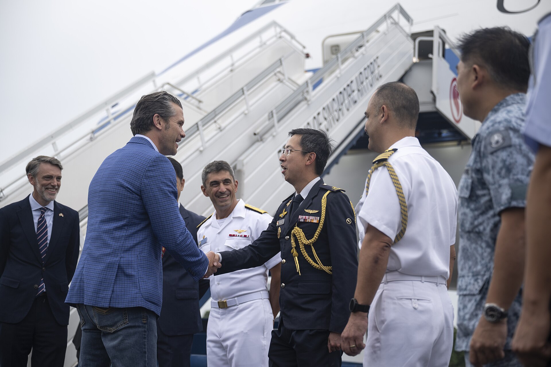 US Secretary of Defense Pete Hegseth arrives in Singapore for the Shangri-La Dialogue, greeted by Singapore Air Force Brigadier General Simon Lee, May 30, 2025