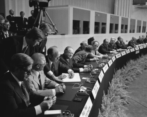 Leaders of 35 nations sign the Helsinki Final Act at Finlandia Hall, August 1, 1975 — including Gerald Ford, Leonid Brezhnev, and Helmut Schmidt at the long ceremonial table