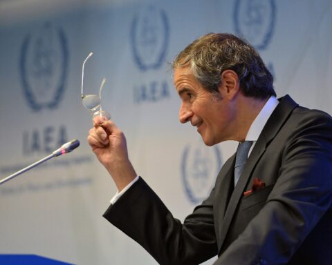 IAEA Director General Rafael Grossi at a press briefing with IAEA logos displayed behind him, speaking on Iran nuclear programme verification