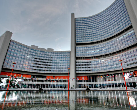 Vienna International Centre, headquarters of the IAEA, with curved glass towers and UN member state flags, Vienna, Austria