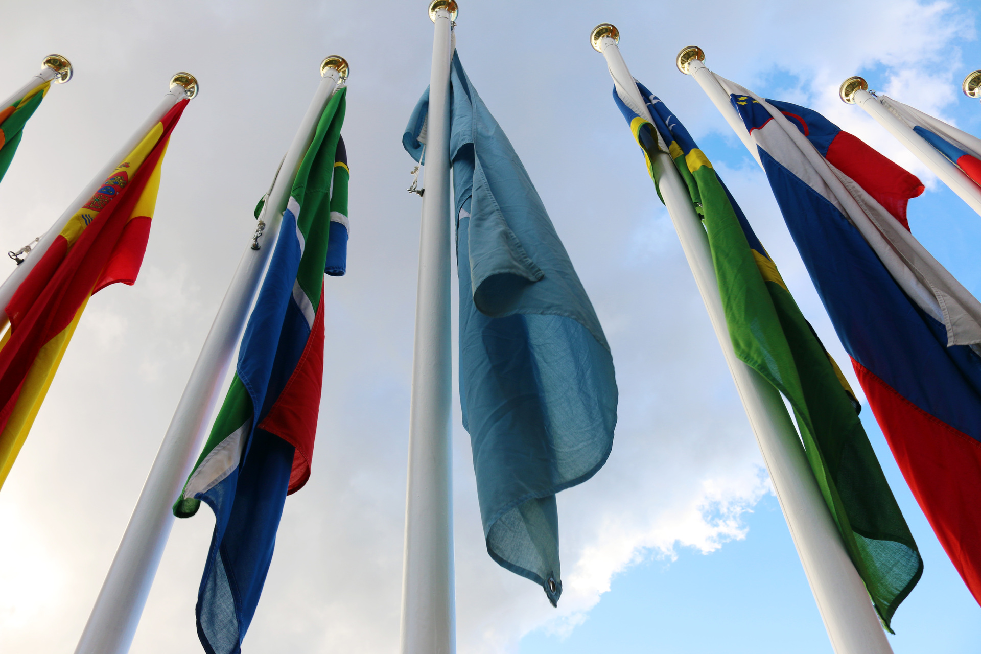 Member state flags at the International Maritime Organization headquarters in London, where IMO Secretary-General Dominguez issued evacuation corridor demands for trapped Gulf seafarers