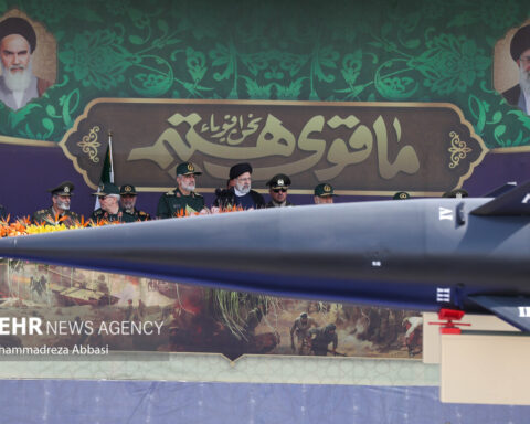 Iranian IRGC generals review a ballistic missile at the Sacred Defence Week parade in Tehran, September 2023, flanked by portraits of Khomeini and Khamenei