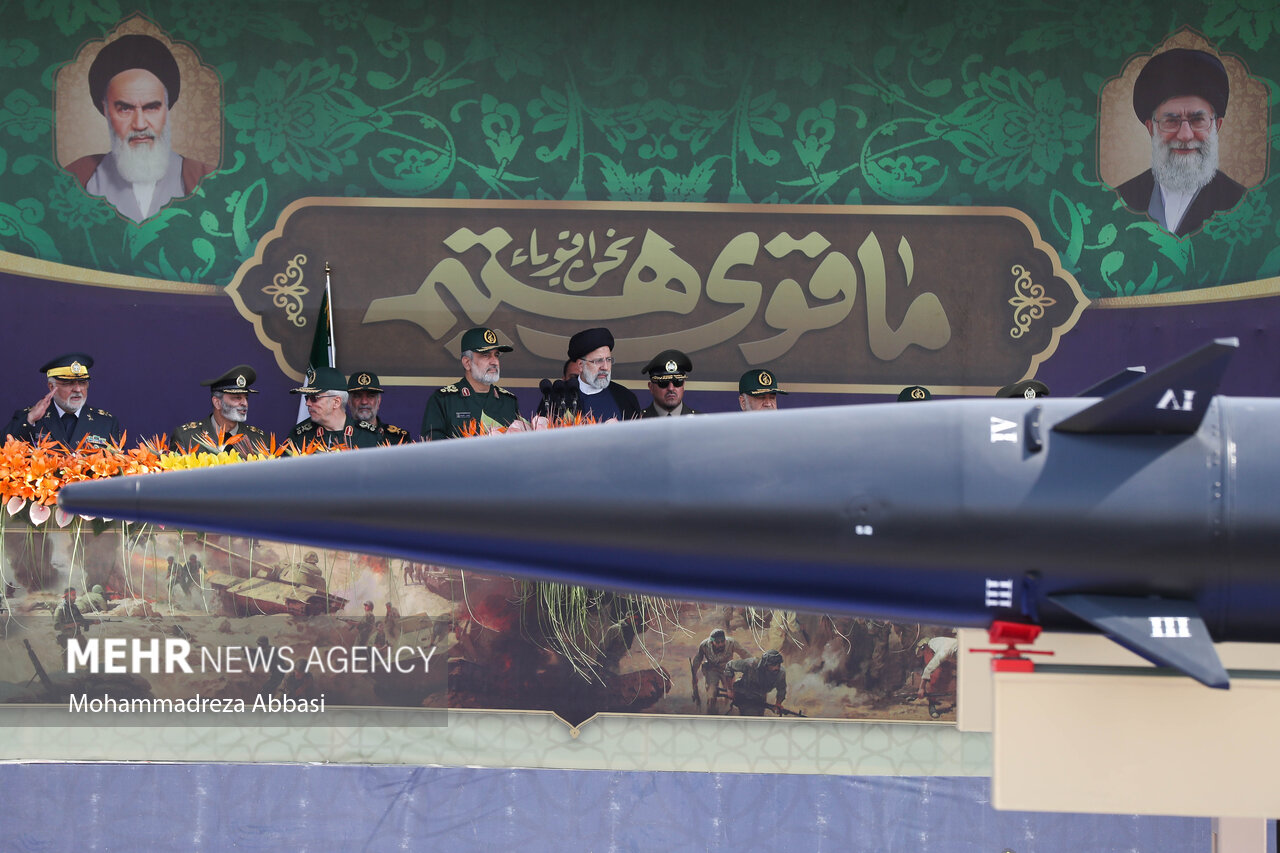 Iranian IRGC generals review a ballistic missile at the Sacred Defence Week parade in Tehran, September 2023, flanked by portraits of Khomeini and Khamenei