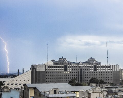 Iran Majlis parliament building in Tehran during a lightning storm, seen from rooftop across the city skyline