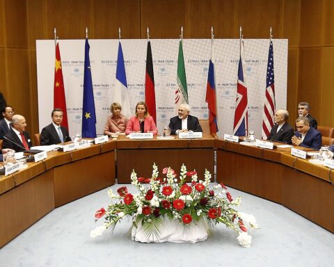 US and Iranian negotiators at the Iran nuclear talks table in Vienna, July 2015, with P5+1 flags visible