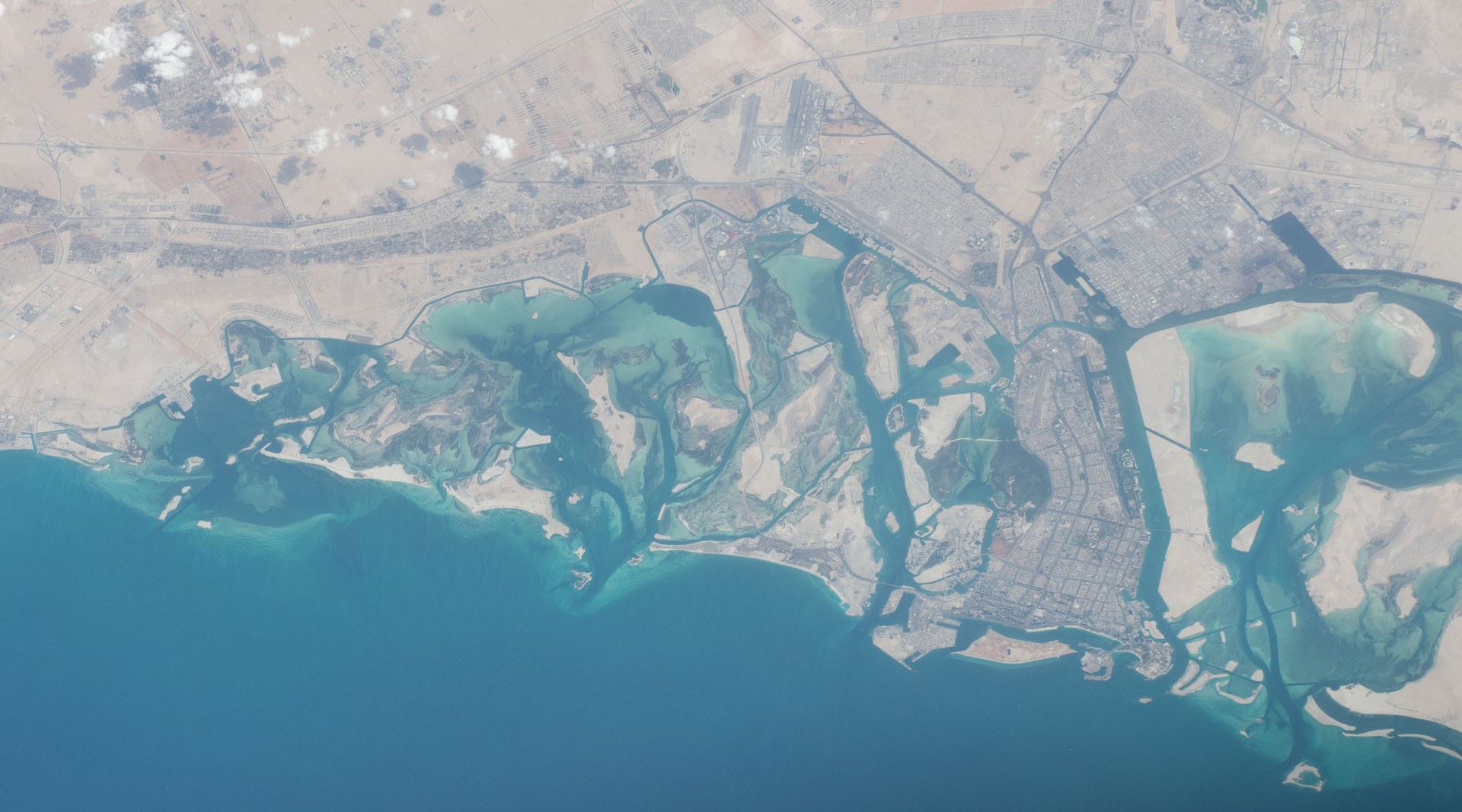 Abu Dhabi coastline and Saadiyat Island from the International Space Station — the UAE absorbed 73 percent of all Iranian ordnance fired at GCC states while Saudi Arabia declined to coordinate a joint response