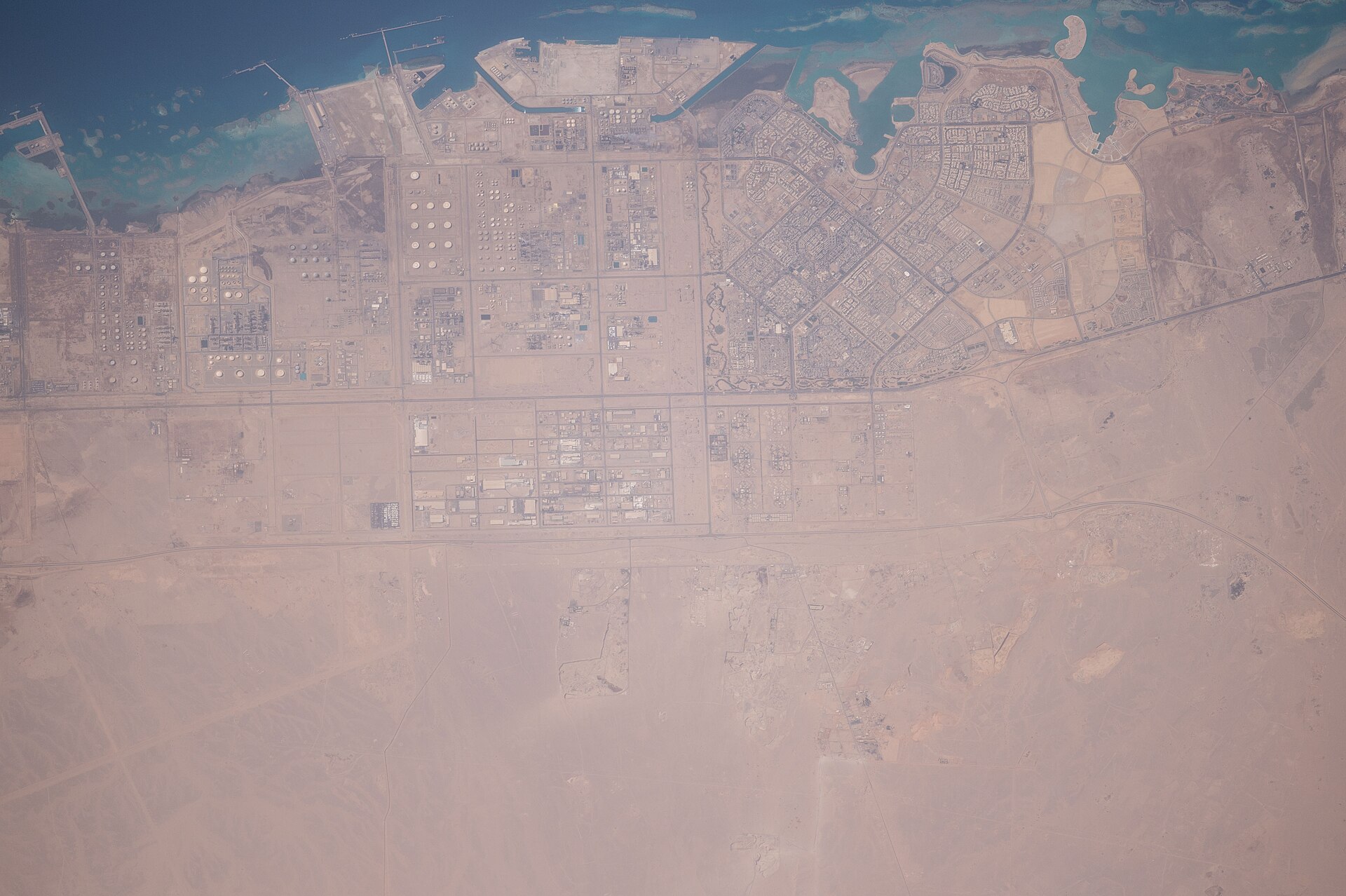 Saudi oil and industrial infrastructure on the Gulf coast from ISS — Aramco production dropped 30 percent from February to March 2026 as Hormuz effectively closed