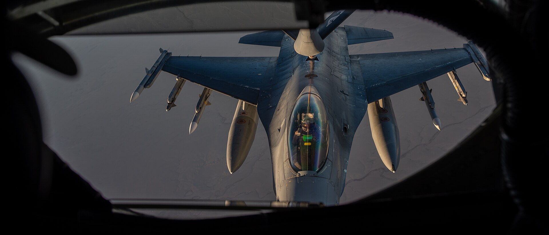 KC-135 Stratotanker boom operator view refueling an armed F-16 Fighting Falcon over the USCENTCOM area of responsibility. USAF photo.