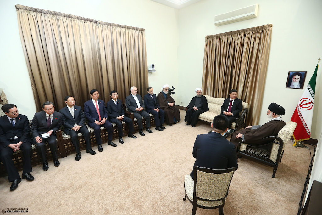 Supreme Leader Ali Khamenei receiving foreign dignitaries in his official meeting room, with Iranian flag and portrait of Imam Khomeini visible