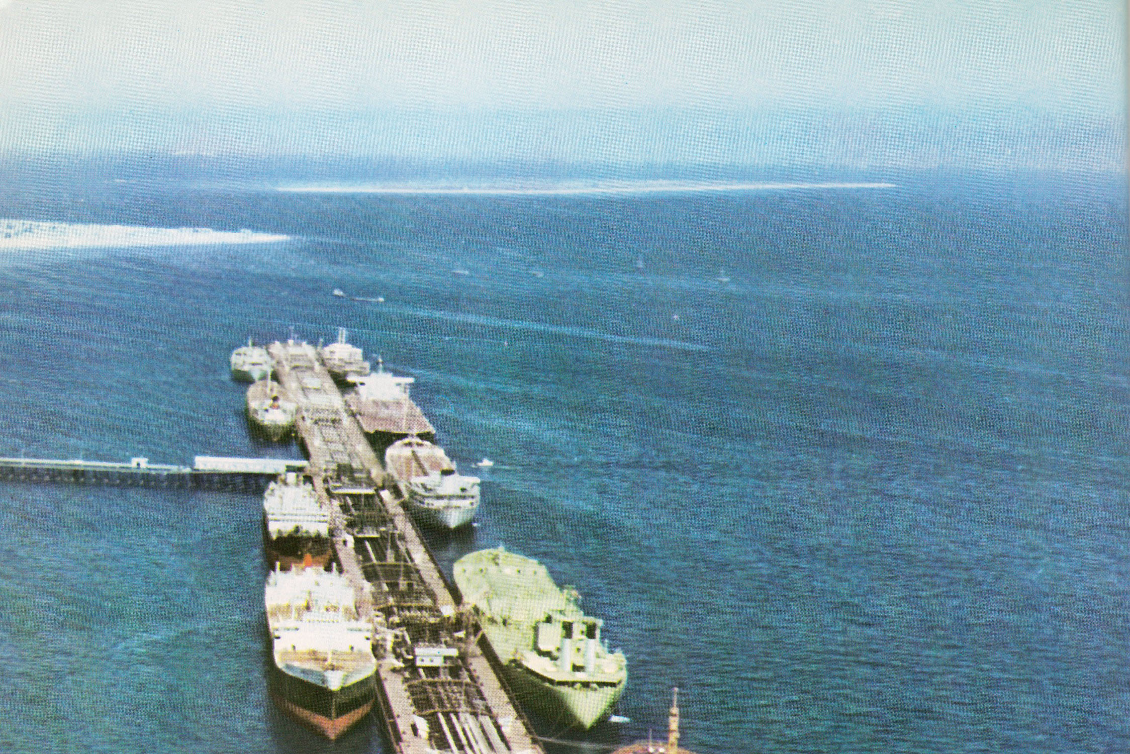 Kharg Island oil loading terminal — Iran handles over 90% of its crude oil exports through this facility in the Persian Gulf. Storage tanks at Kharg were at 74% capacity in May 2026 with approximately one month of margin before tank tops would force production shutdowns