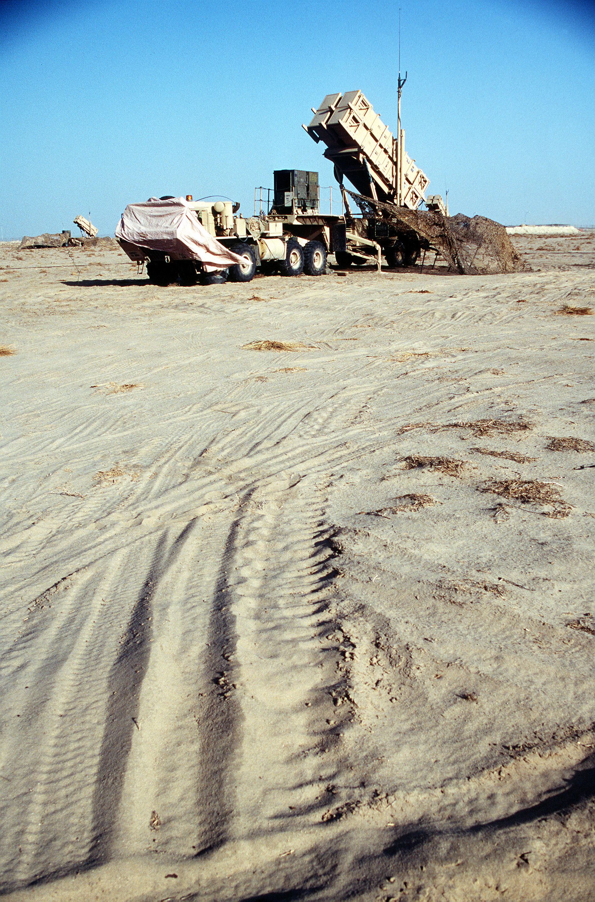U.S. Army Patriot surface-to-air M901 missile launcher deployed in the Kuwait desert near Camp Doha — Kuwait intercepted 97 post-ceasefire ballistic missiles with its Patriot network while no GCC partner coordinated a collective air defense response