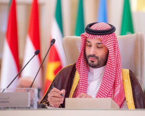 Mohammed bin Salman chairs the Extraordinary Arab and Islamic Summit in Riyadh, November 2024, with national flags of member states behind him