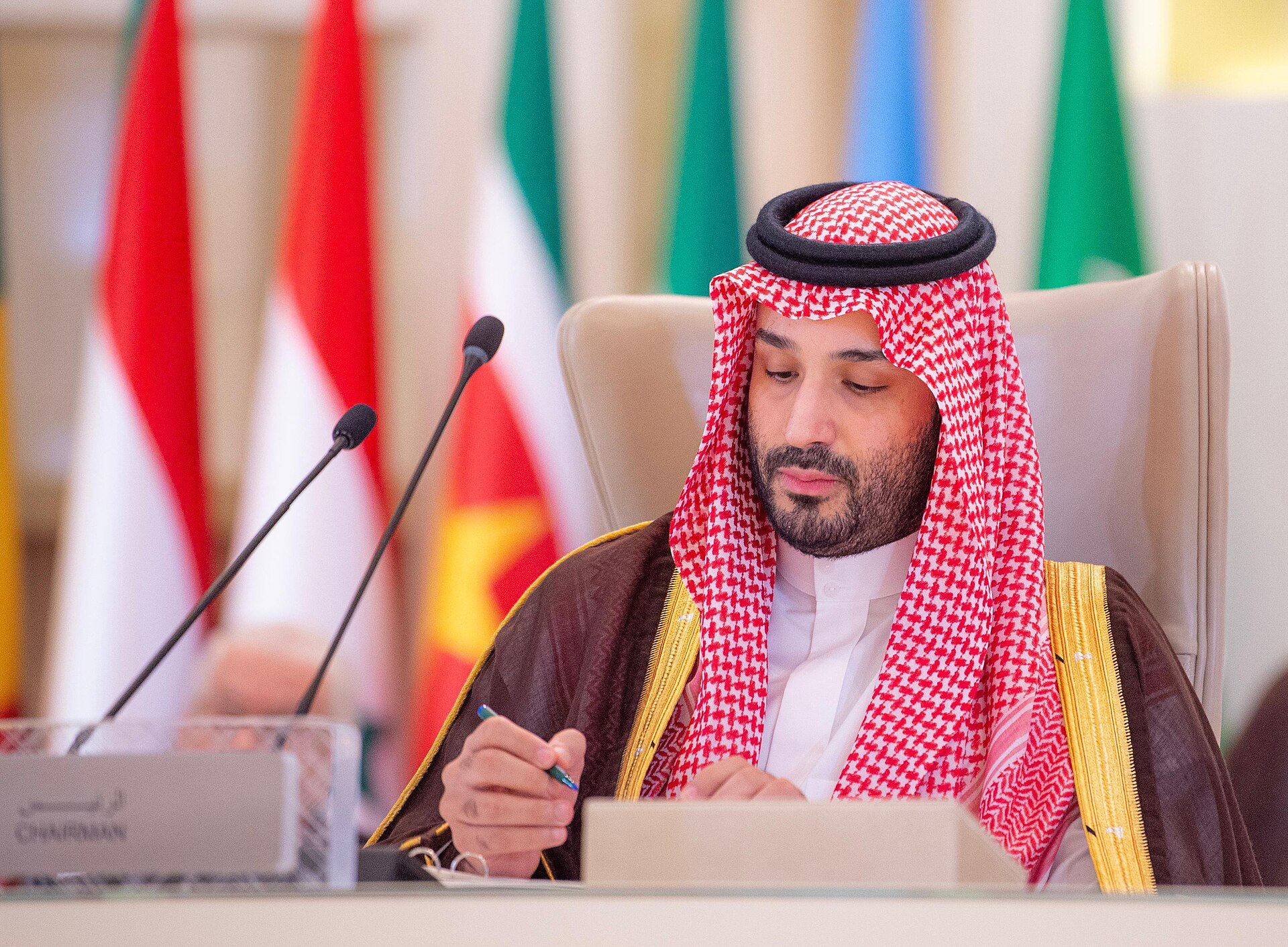 Mohammed bin Salman chairs the Extraordinary Arab and Islamic Summit in Riyadh, November 2024, with national flags of member states behind him