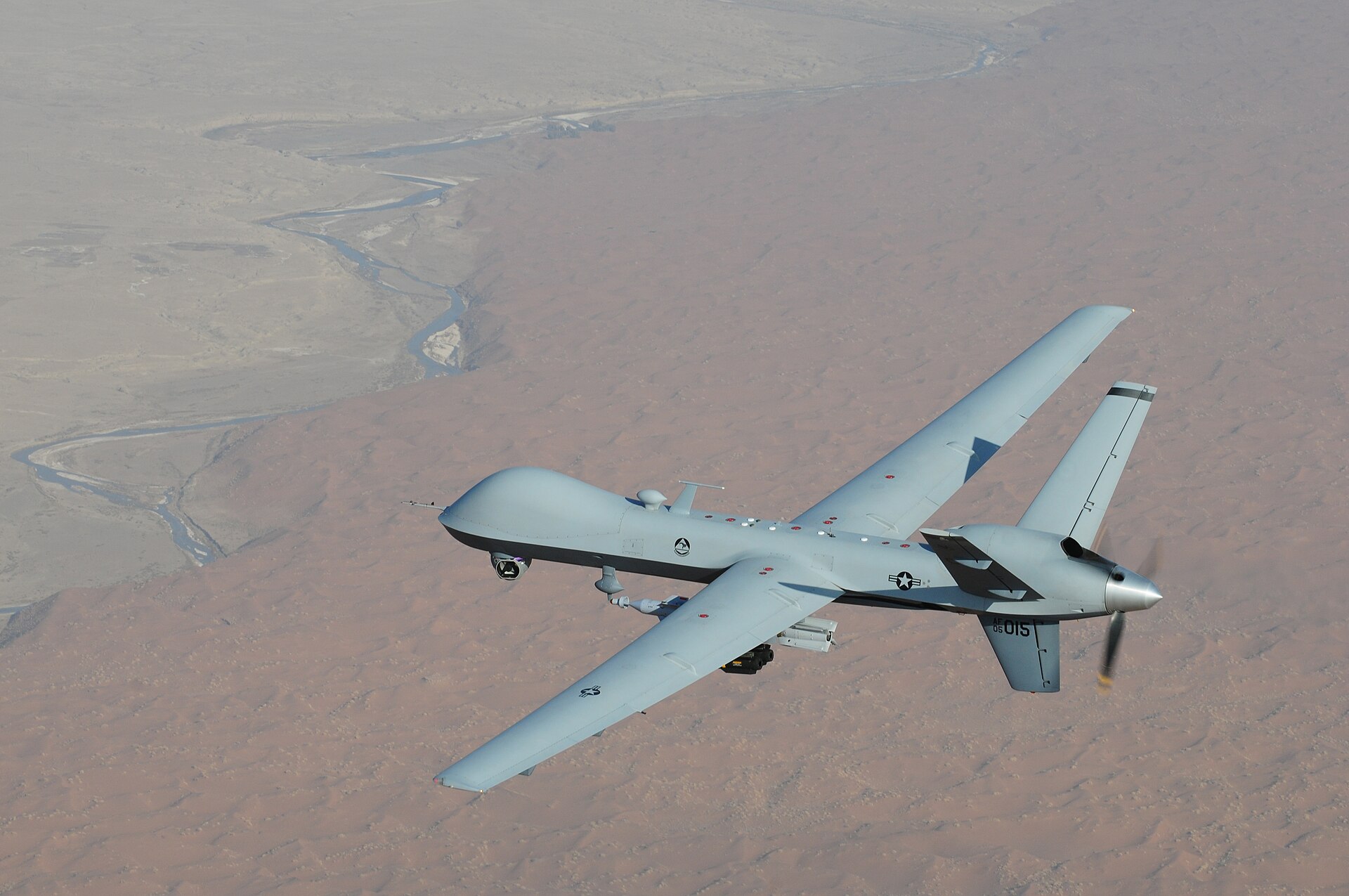 A US Air Force MQ-9 Reaper unmanned aircraft in flight over desert terrain, the aircraft type that sustained at least 25 confirmed total losses during the Iran conflict including two at Ali Al Salem on May 30 2026