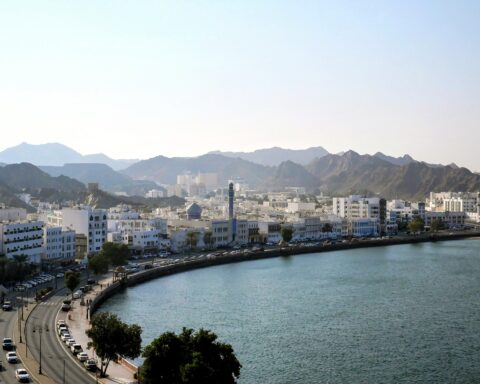 Muttrah Corniche aerial view, Muscat, Oman — host city for all four rounds of indirect US-Iran nuclear talks in 2026