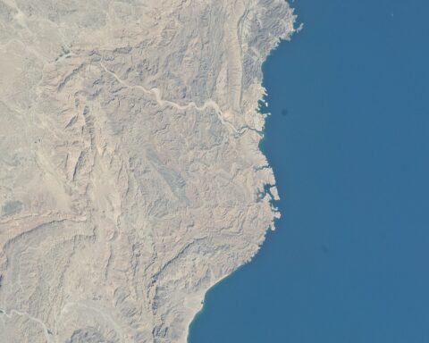 Muscat Bay coastline from NASA astronaut photography — the diplomatic quarter where four rounds of US-Iran nuclear talks have been hosted by Oman