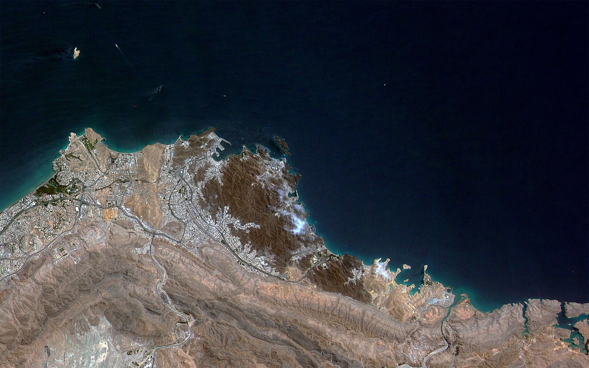 Satellite view of Muscat, Oman — host city for all four rounds of indirect US-Iran nuclear talks in 2026