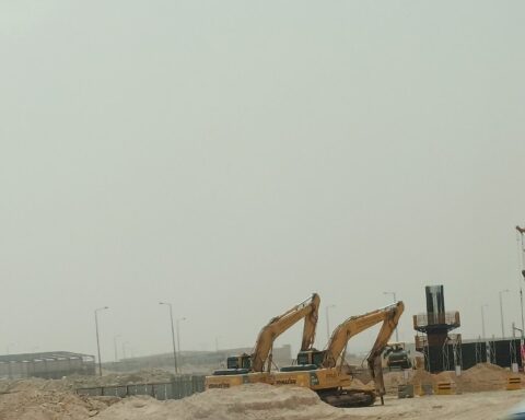 Construction excavators and cranes at a Saudi desert infrastructure project site, Riyadh, Saudi Arabia