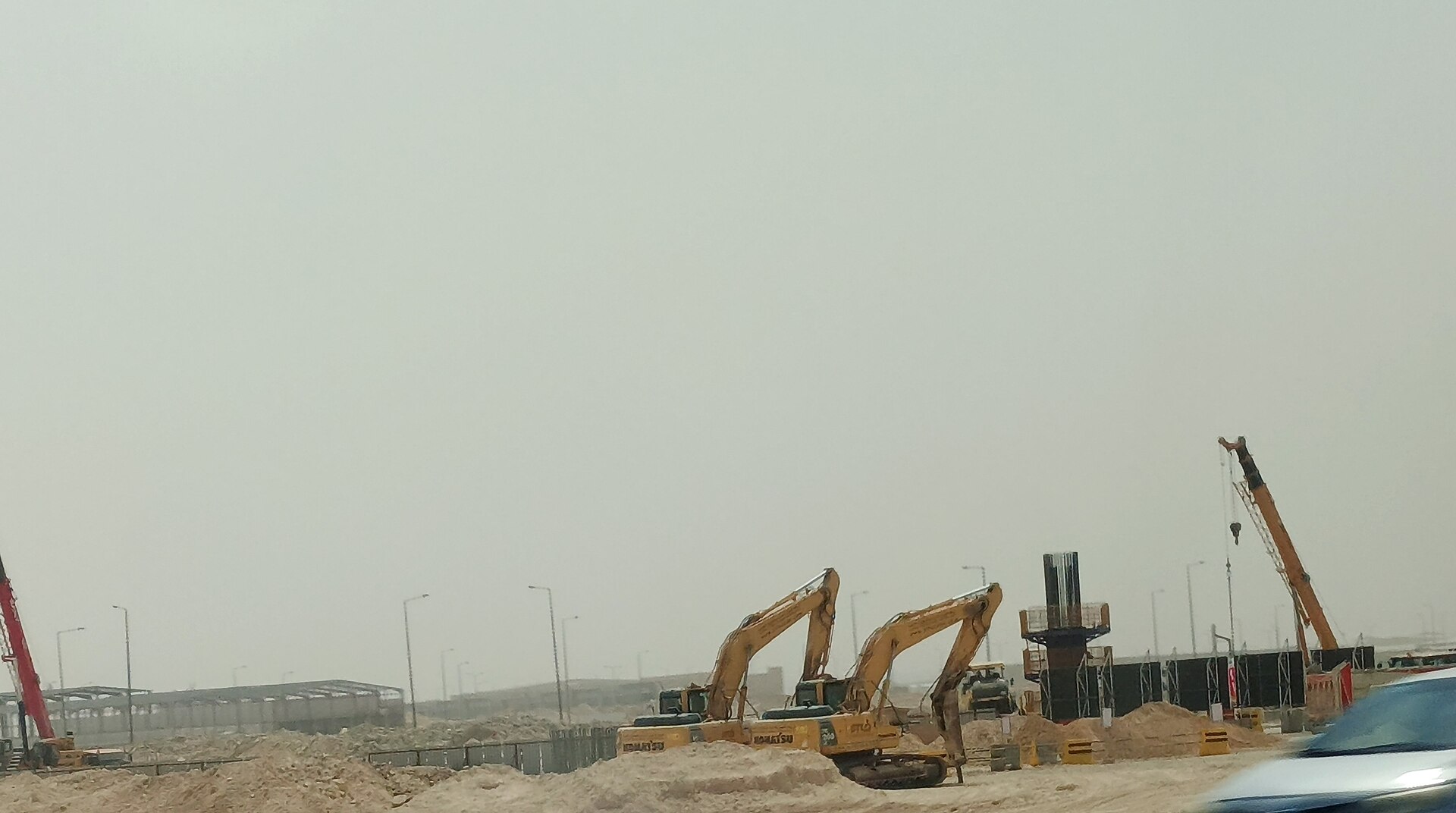 Construction excavators and cranes at a Saudi desert infrastructure project site, Riyadh, Saudi Arabia