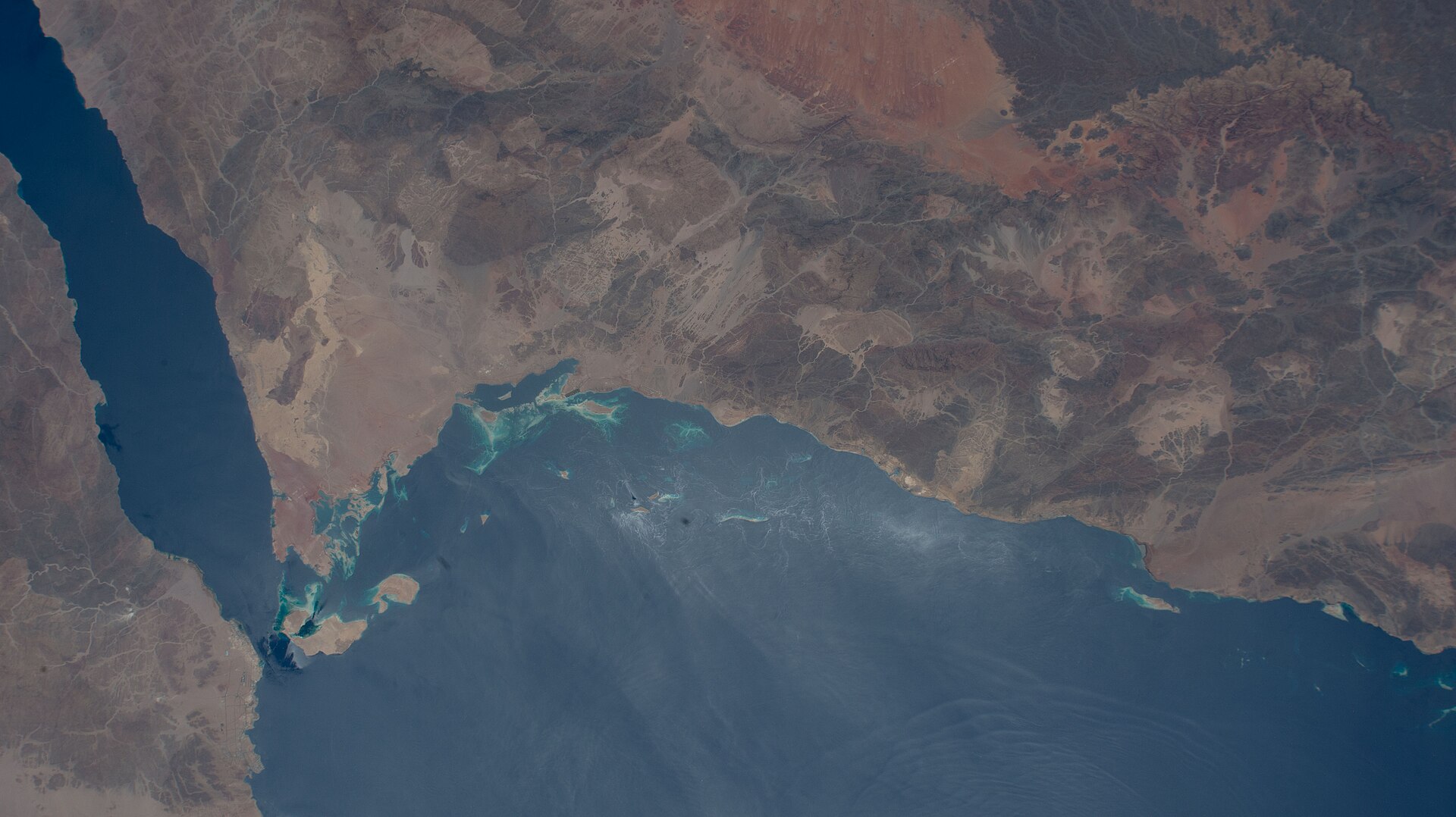 ISS Expedition 67 aerial view of the Red Sea coast and Gulf of Aqaba, showing the Tabuk province desert terrain where NEOM is under construction