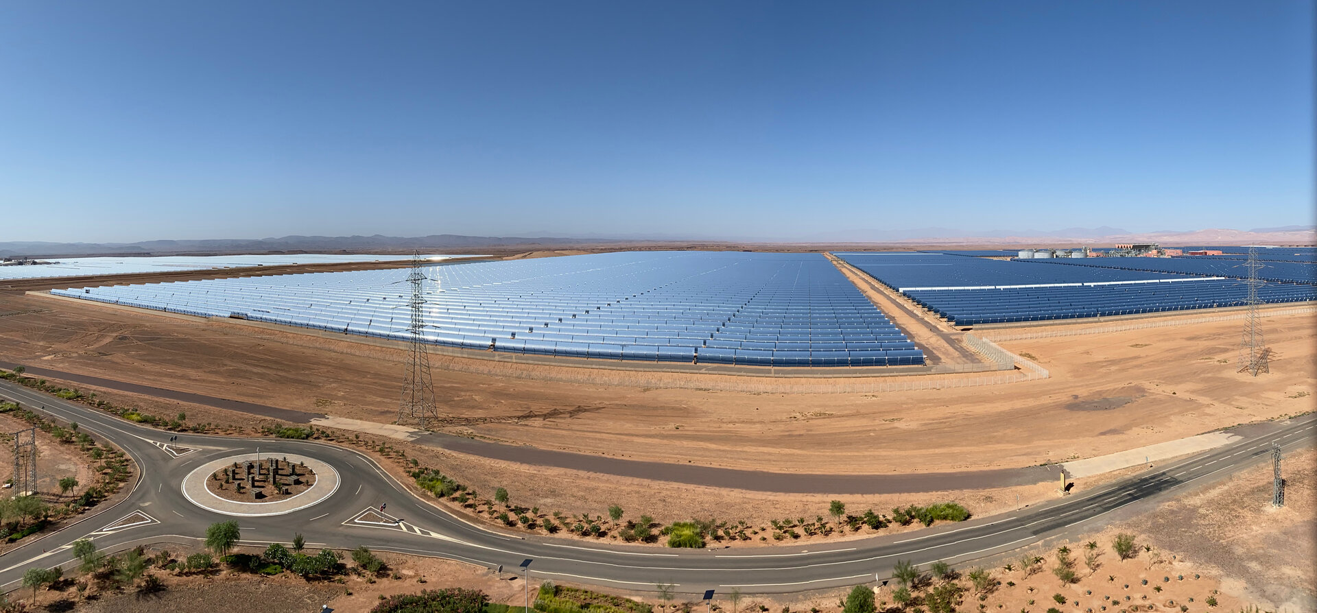 The Noor I and Noor II parabolic trough concentrated solar power stations at Ouarzazate, Morocco, built and operated by ACWA Power — the same consortium partner leading the NEOM Green Hydrogen Company 4GW solar and wind infrastructure in Tabuk province. Photo: Richard Allaway / Flickr CC BY 2.0