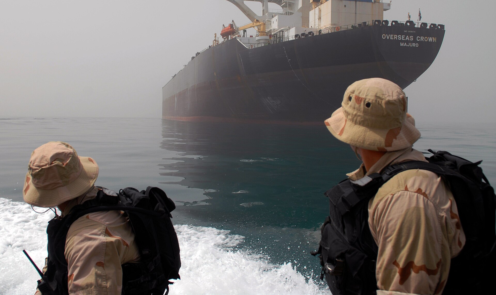 US Navy sailors aboard a rigid-hull inflatable boat approach the oil tanker Overseas Crown in the Persian Gulf, 2007