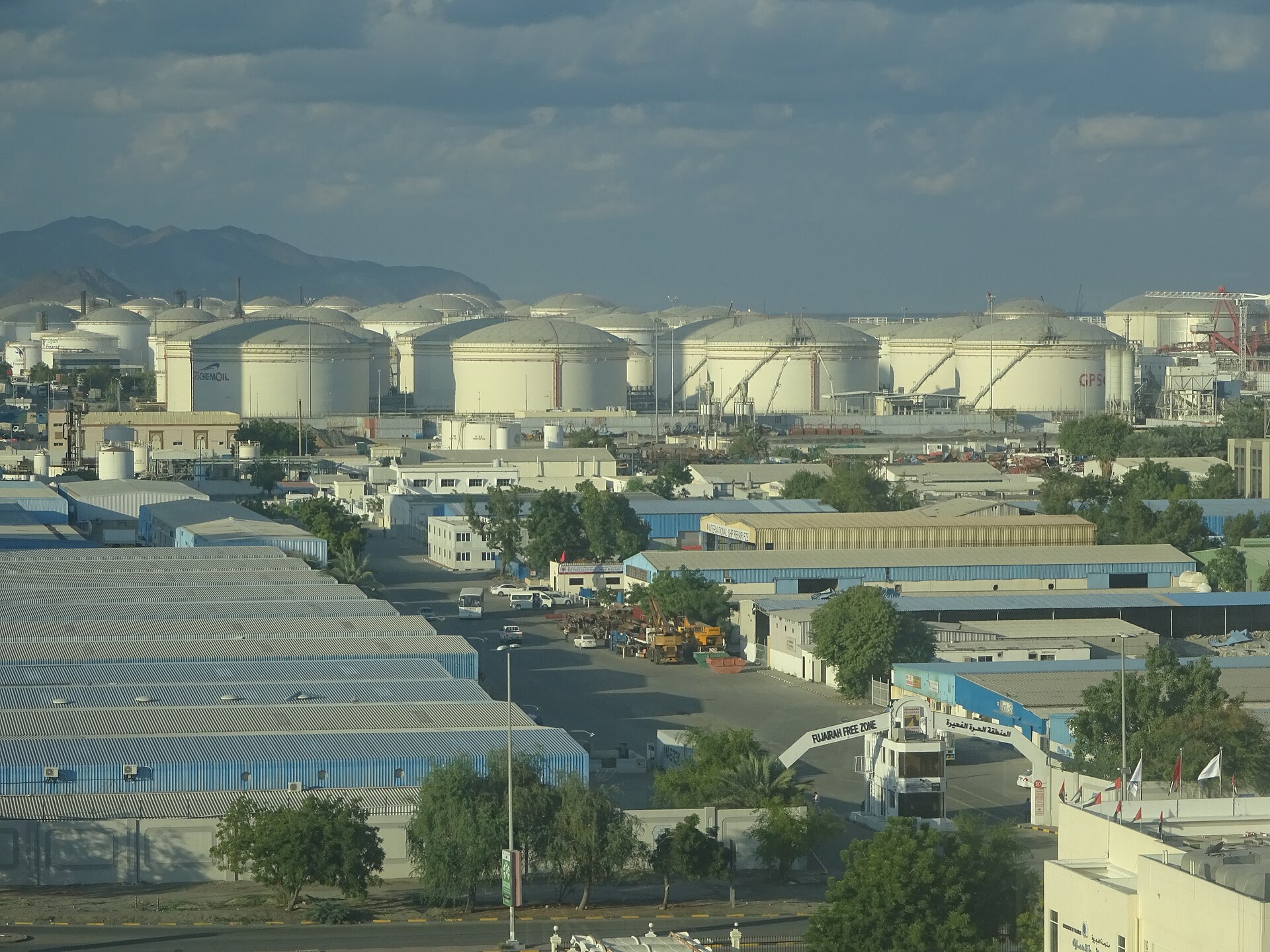Oil storage tanks at Fujairah Port, UAE — the eastern terminus of the Abu Dhabi Crude Oil Pipeline (ADCOP), a 1.8-million-barrel-per-day bypass route that Iran's May 22 jurisdiction map drew a surveillance zone over