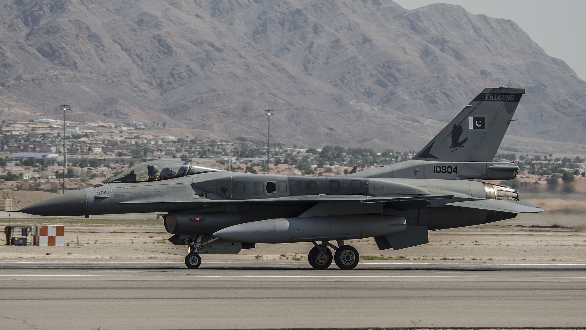 A Pakistan Air Force F-16C Fighting Falcon on the taxiway — the aircraft type that made its first non-stop deployment from Islamabad to Saudi Arabia during Exercise Spears of Victory in January 2026, the same month Pakistani troops with Chinese missile systems reached 8,000 on Saudi soil
