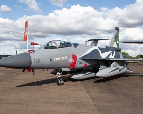 Pakistan Air Force JF-17 Thunder Block III fighter jet on tarmac, Pakistani flag on tail, deployed to Saudi Arabia under the SMDA defence pact