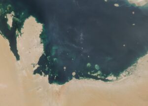NASA MODIS satellite image of the Persian Gulf showing the Arabian Peninsula coastline and southern Gulf states — UAE, Qatar, and Kuwait visible along the shore — targeted by Iranian drone strikes on May 10, 2026