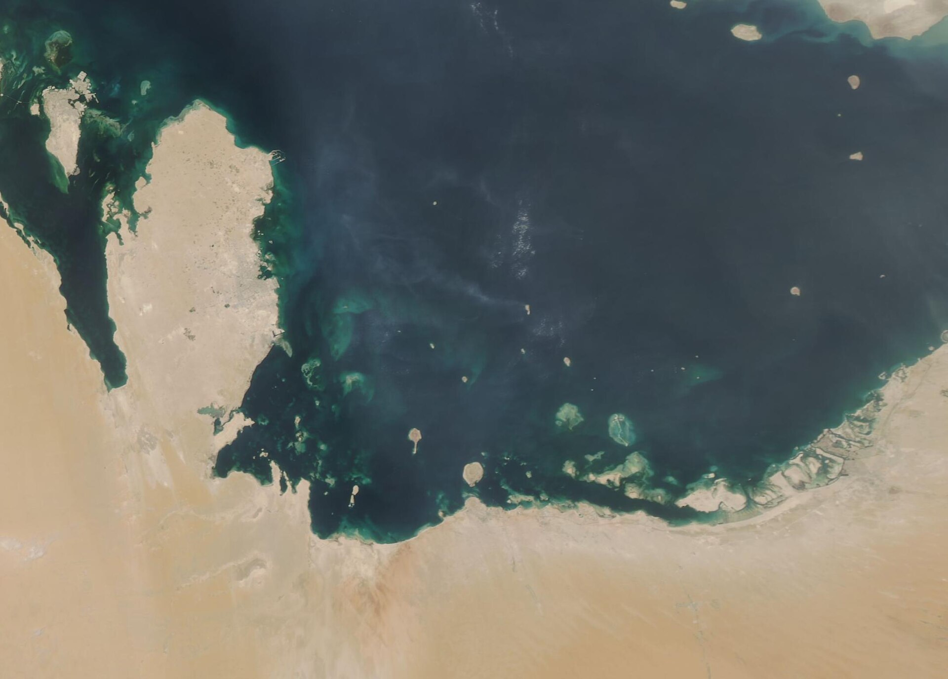 NASA MODIS satellite image of the Persian Gulf showing the Arabian Peninsula coastline and southern Gulf states — UAE, Qatar, and Kuwait visible along the shore — targeted by Iranian drone strikes on May 10, 2026