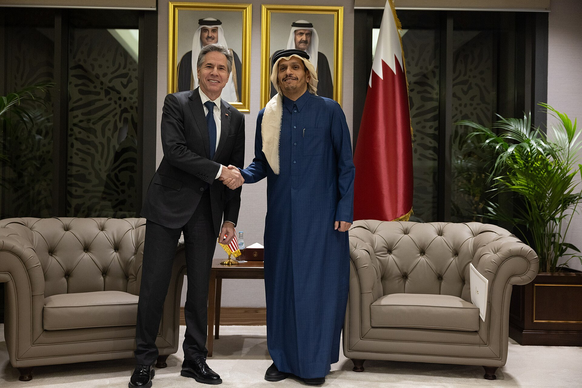 Qatar Prime Minister Sheikh Mohammed bin Abdulrahman Al Thani in diplomatic meeting, Qatar flag behind, Doha