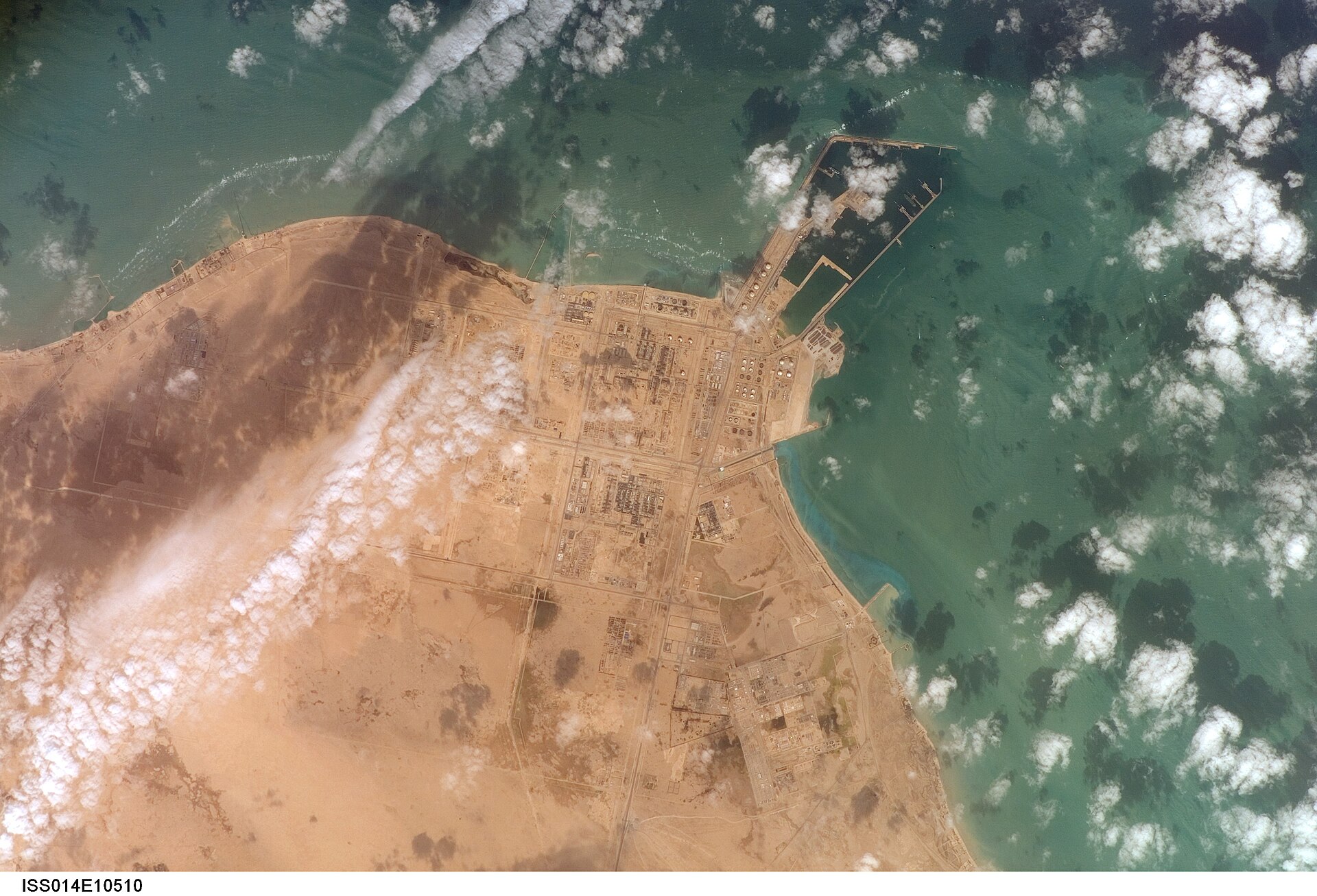 NASA satellite image of Ras Laffan Industrial City, Qatar's LNG export hub on the Persian Gulf coast, supplying approximately 20 per cent of global LNG — all of it dependent on Hormuz transit