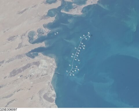 NASA ISS satellite view of Ras Tanura, Saudi Arabia, showing offshore oil loading berths extending into the Persian Gulf.