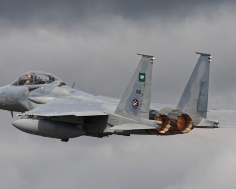 Royal Saudi Air Force F-15SA Eagle fighter jet departing on afterburner, Saudi flag on tail fin — the platform at the centre of the kingdom's confirmed co-belligerency in the US-Iran war