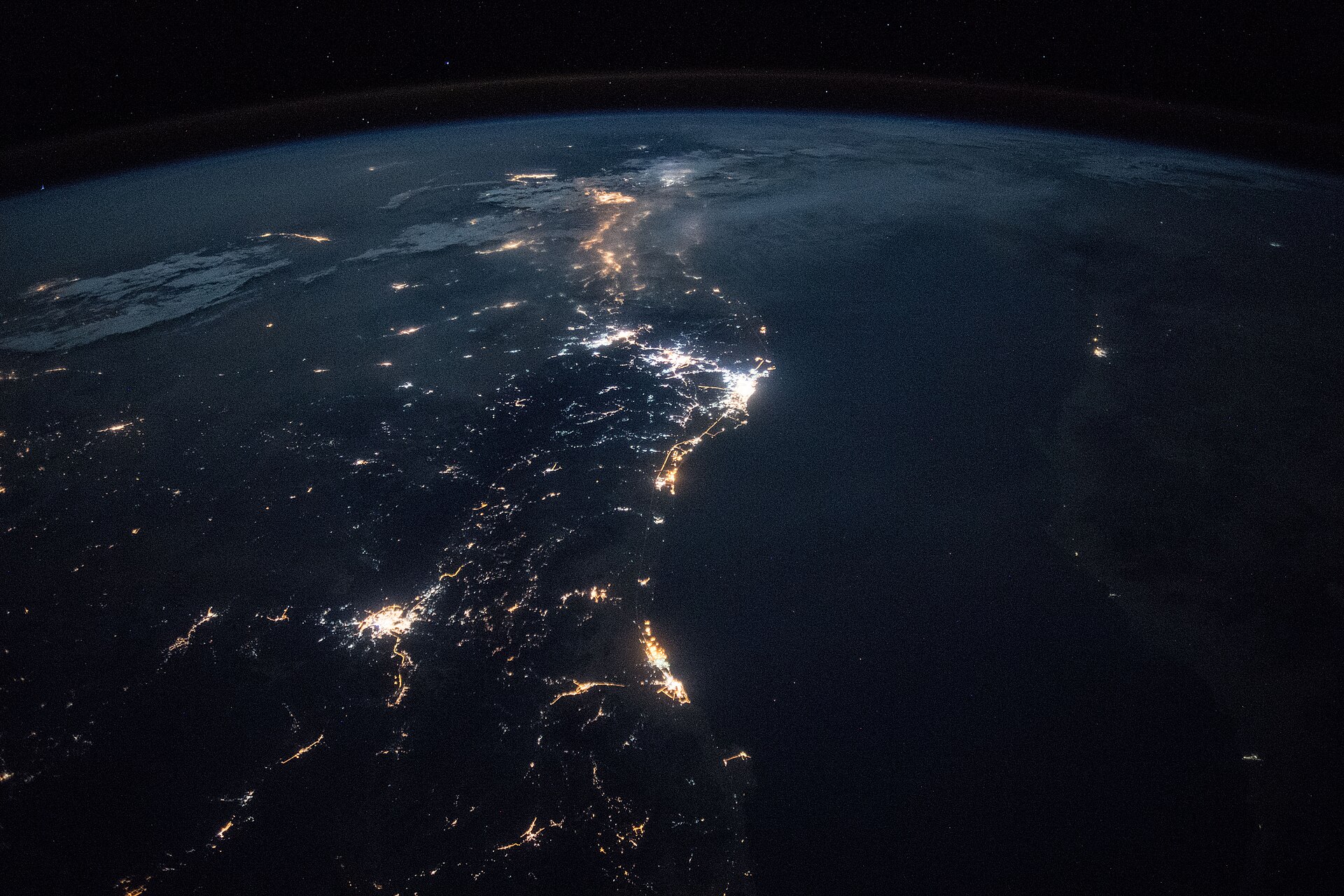 Saudi Arabia Red Sea coastline photographed at night from the International Space Station, showing city lights along the Arabian Peninsula. NASA photo, ISS Expedition 55.