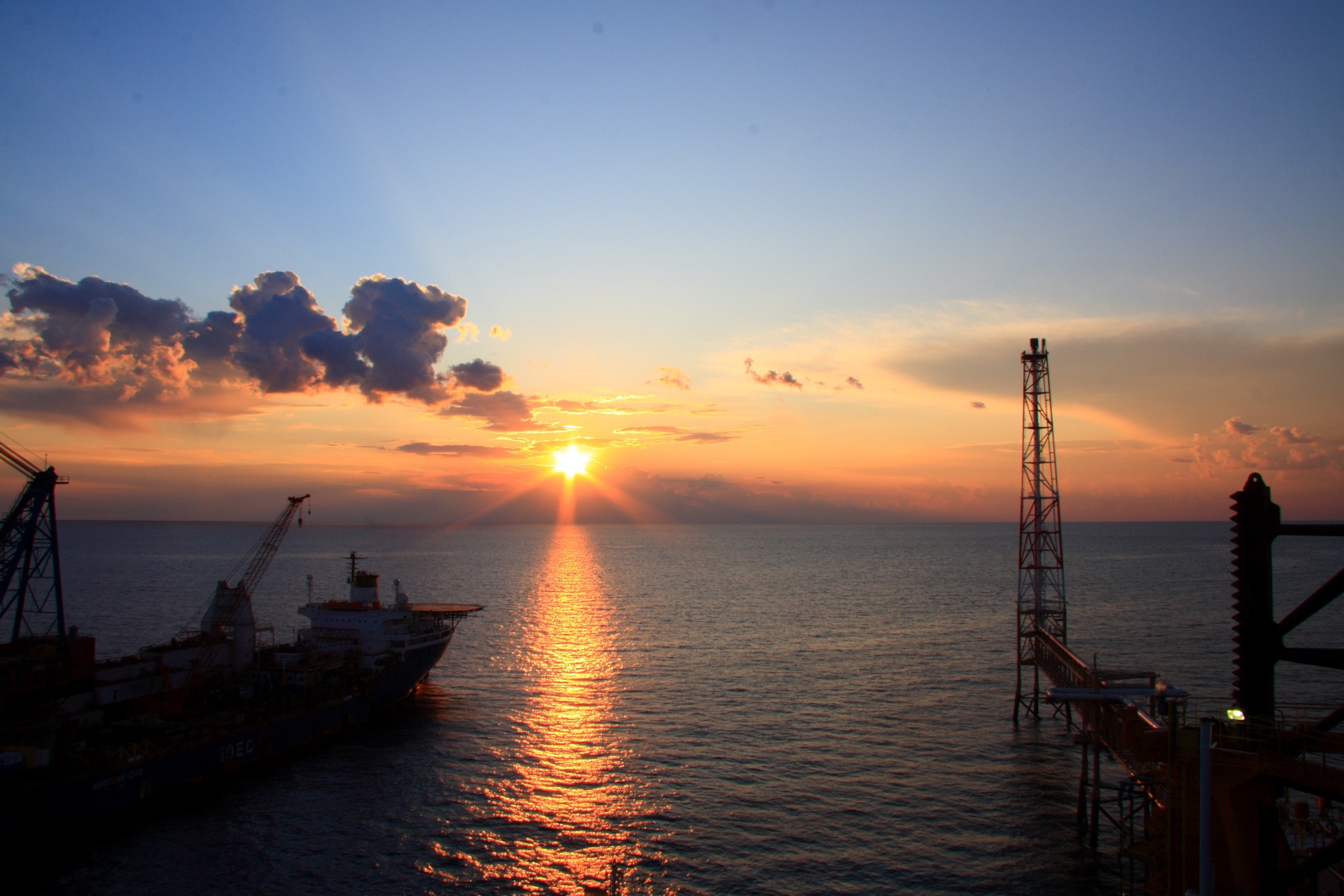 South Pars gas field offshore platform in the Persian Gulf at sunset, shared North Field South Pars reservoir Qatar Iran