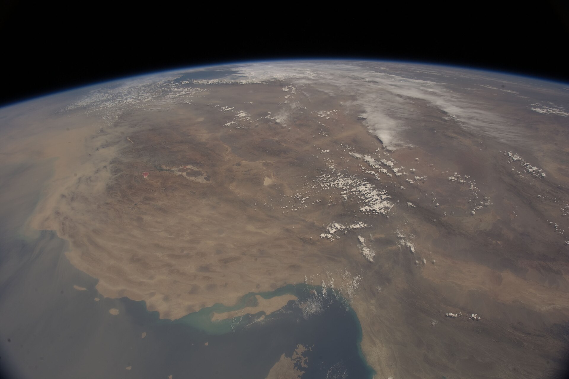 The Strait of Hormuz and Persian Gulf region photographed from the International Space Station, showing the narrow waterway between Iran and the Arabian Peninsula