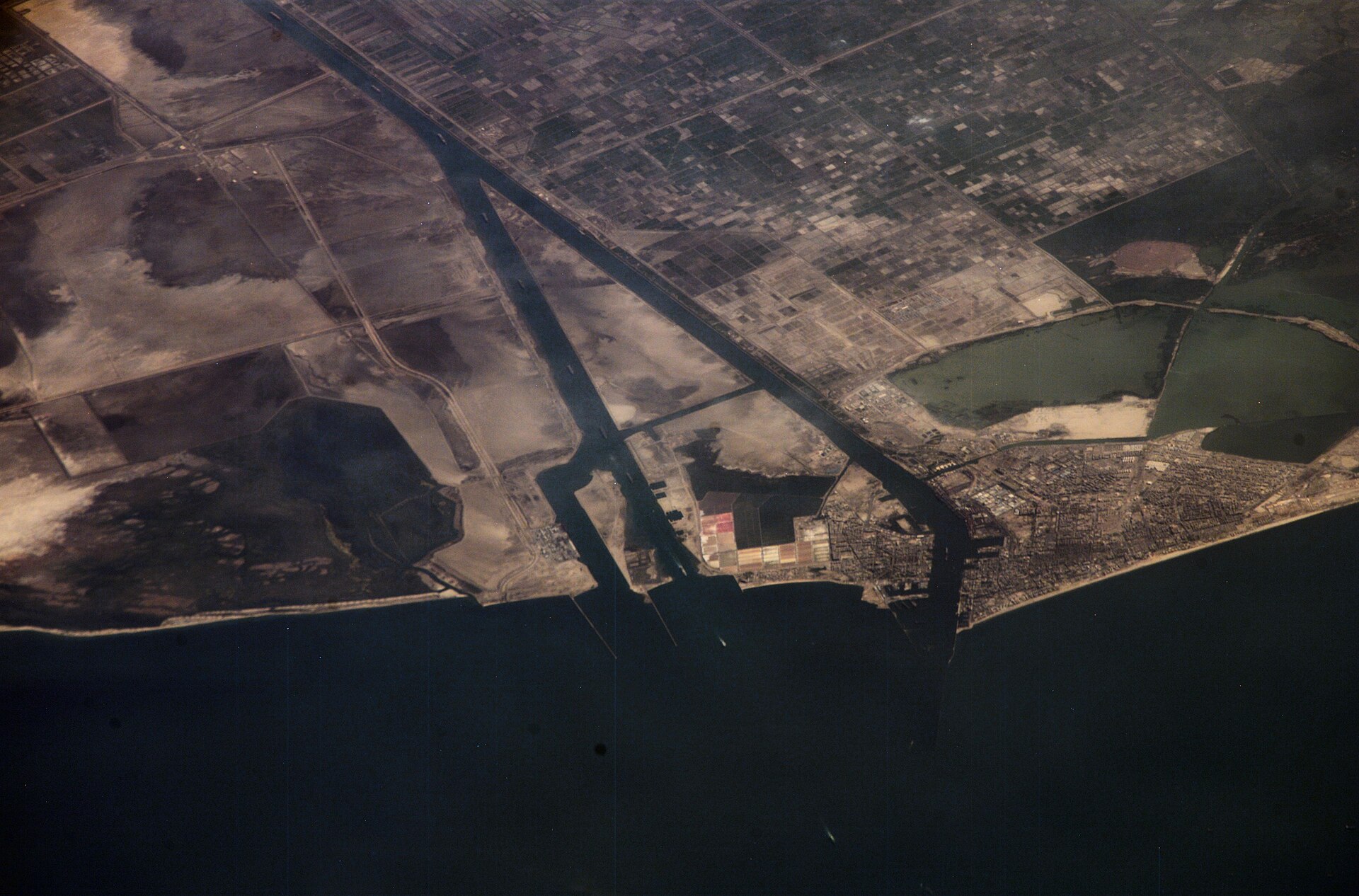 NASA ISS astronaut photograph of Suez Canal entering the Mediterranean Sea at Port Said, Egypt — the transit route for Yanbu-loaded Saudi crude bound for European refineries now facing Houthi threat claims