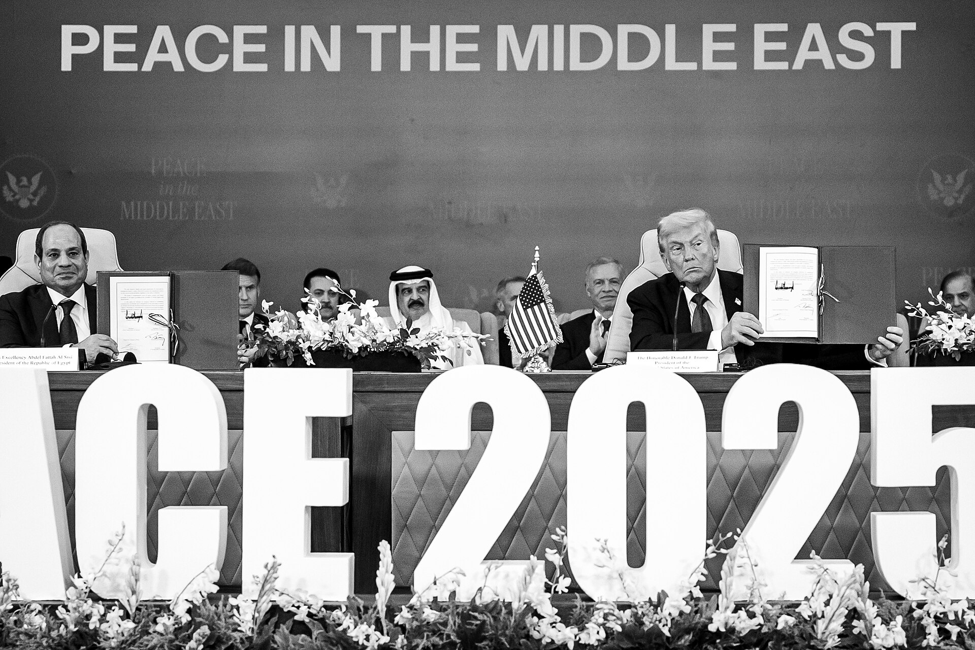 Trump holds ceasefire agreement document at Middle East Peace signing ceremony, January 2025